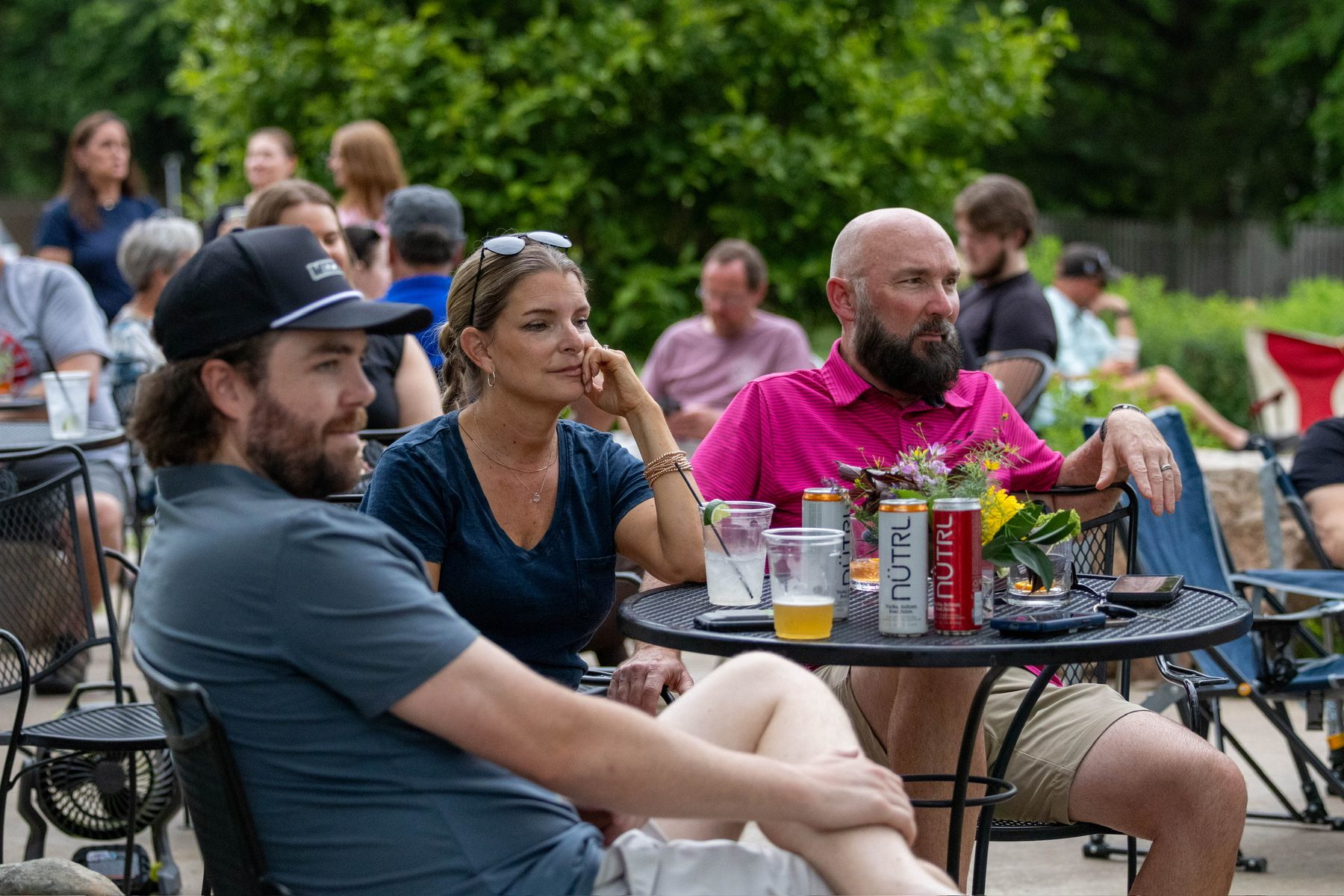 Friends enjoying drinks at a patio table